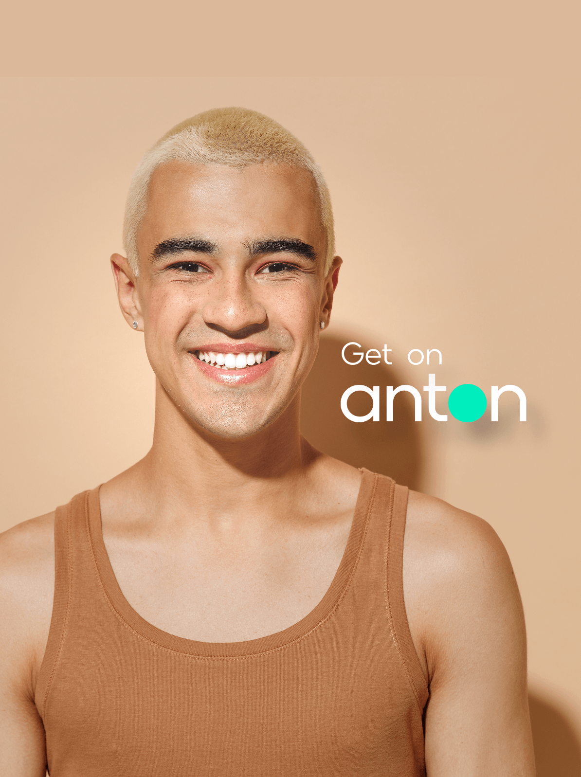 Get on anton — smiling man against a peach background
